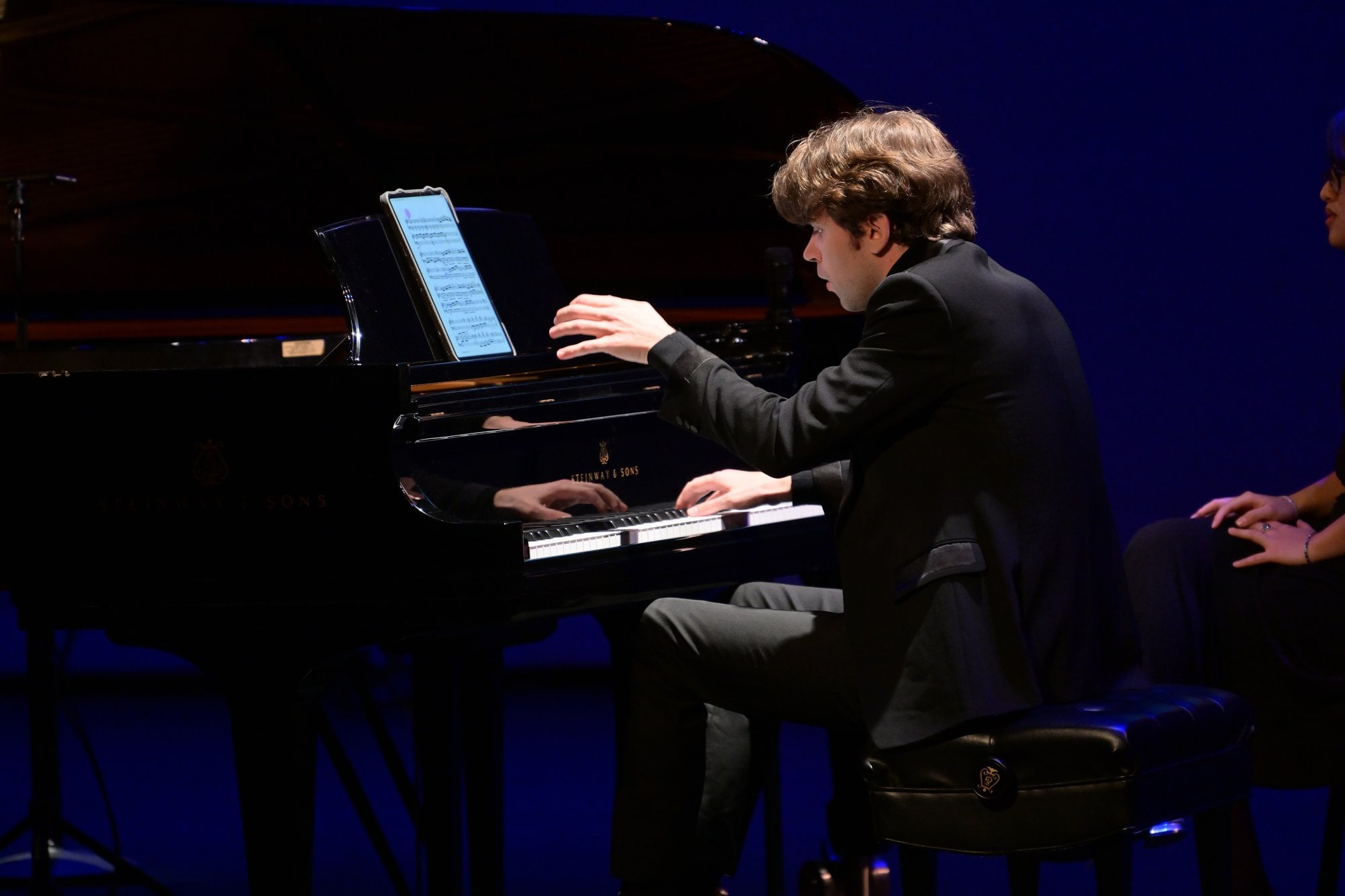 A pianist at work, with the score on a tablet